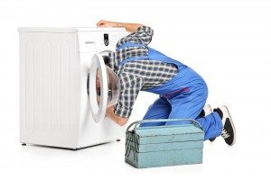 man repairing washing machine