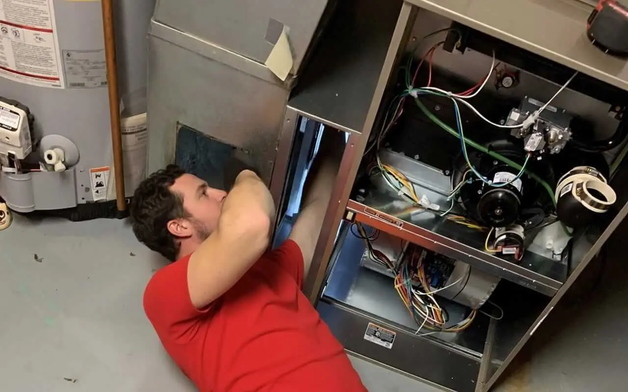 Technician performing furnace repair in Innisfil home before winter - 911 appliance repair services