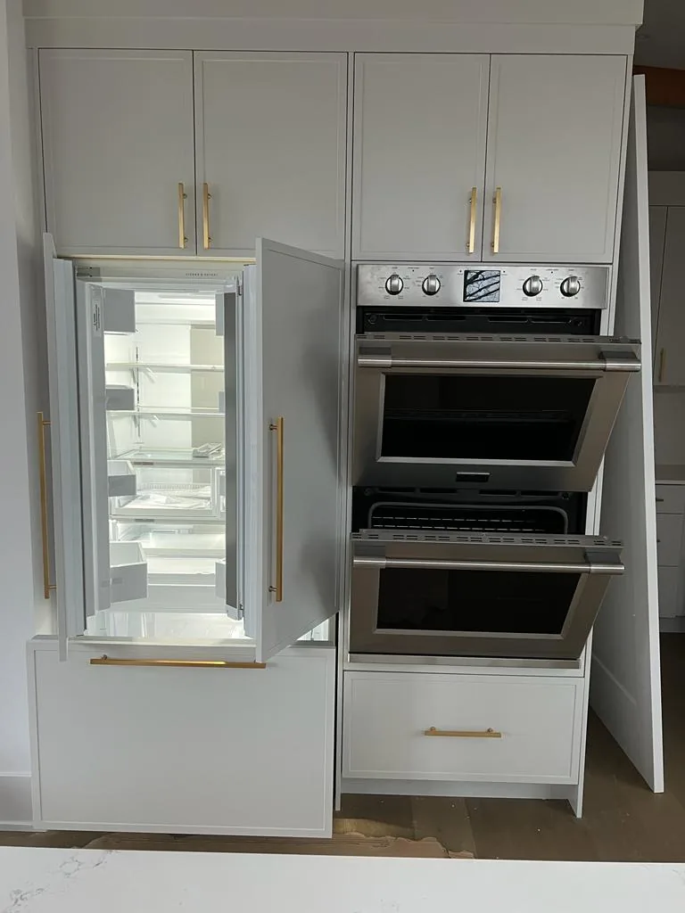 Built-in appliance installation in custom kitchen