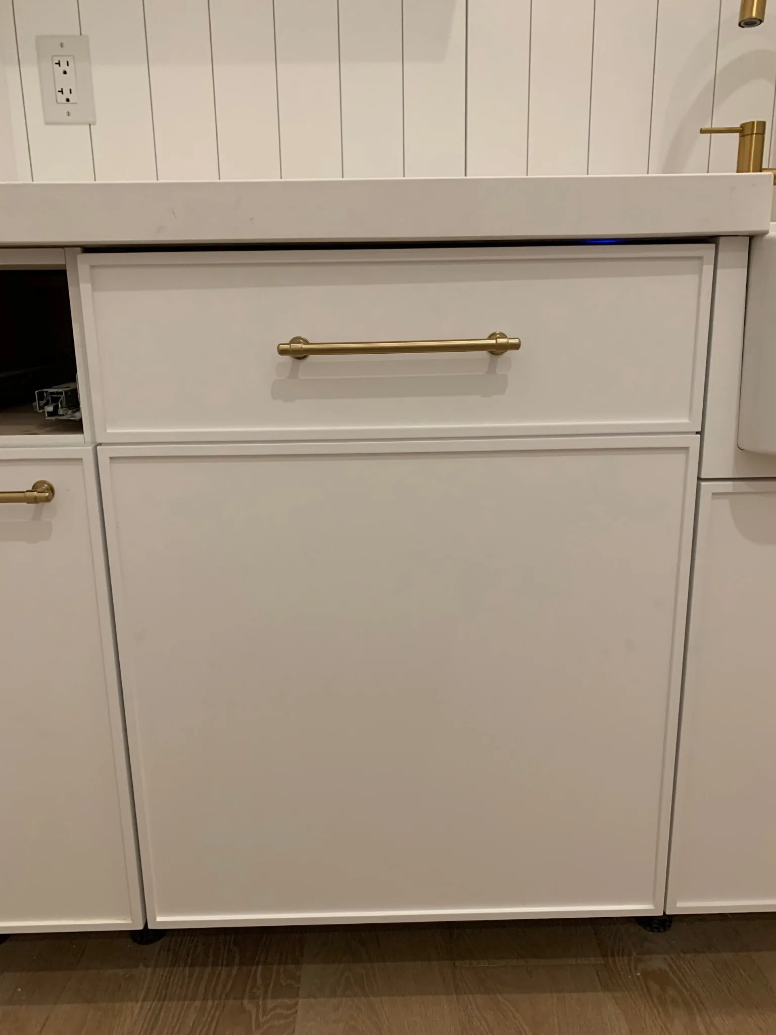 Panel-ready dishwasher installed with custom cabinet panel